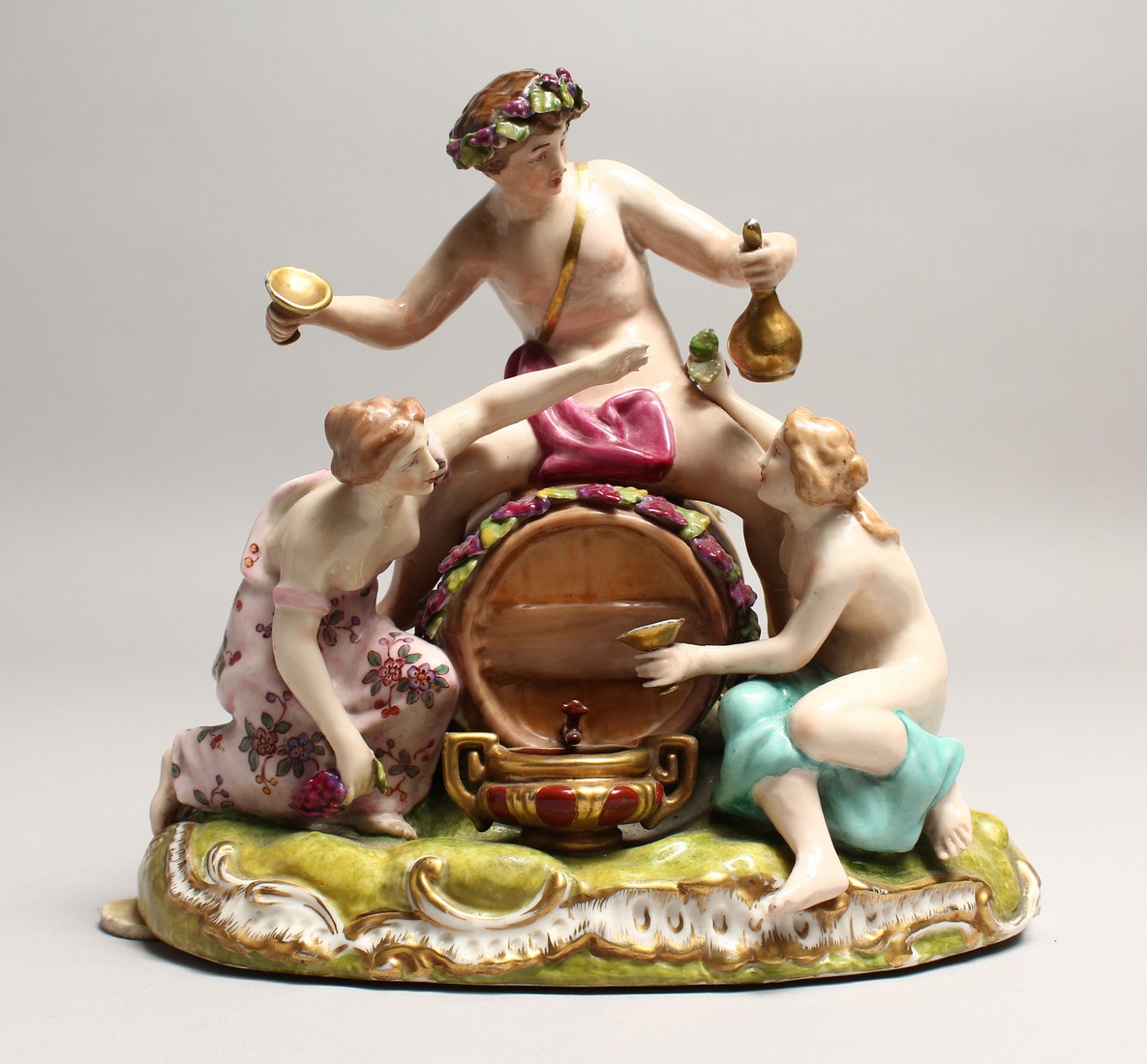 A GOOD 19TH CENTURY CONTINENTAL POTTERY GROUP depicting the grape harvest, one sitting on a