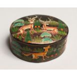 AN OVAL LACQUER BOX painted with deer 3.5ins