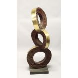 A LARGE POLISHED AND PATTINATED BRONZE ABSTRACT GROUP OF THREE CONJOINED CIRCLES, on a square base.