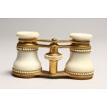 A PAIR OF IVORY AND GILT OPERA GLASSES 4.6ins long.