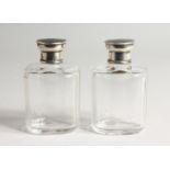 A PAIR OF GLASS SCENT BOTTLES with silver and tortoiseshell tops Initial 'J' Birmingham 1928