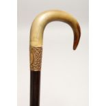 A VERY GOOD 19TH CENTURY RHINO HANDLE WALKING STICK with gilt band 2ft 10ins long