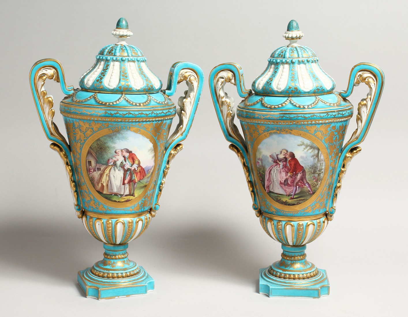 A SUPERB LARGE PAIR OF SEVRES PORCELAIN TWO HANDLED URN SHAPED VASES AND COVERS painted with reverse