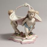 A MEISSEN STYLE PORCELAIN BASKET supported by three cupids. 10ins high