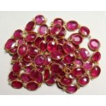 A GOOD 18CT GOLD RUBY SET CHAIN, set with four rubies