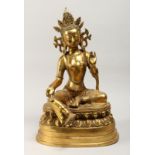 A LARGE CHINESE GILT BRONZE FIGURE OF A SEATED FEMALE DEITY 20ins high.
