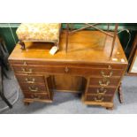 A GEORGIAN MAHOGANY KNEEHOLE DESK, with brushing slide long drawer, oanel door in kneehole flanked