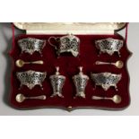 A VERY GOOD SET OF VICTORIAN SILVER CRUETS, comprising four salts and shell spoons, mustard pot