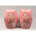 A PAIR OF CHINESE PORCELAIN BARREL SEATS, pink ground, painted with birds. 17ins high.