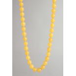 AN AMBER TYPE BEAD NECKLACE with forty two beads