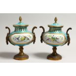A SUPERB PAIR OF SEVRES PORCELAIN ORMOLU MOUNTED CIRCULAR VASES AND COVERS, painted with reverse