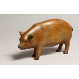 A CARVED WOOD PIG 6ins long