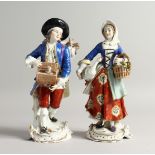 A PAIR OF SAMSON CHELSEA DERBY PORCELAIN FIGURES, a man with a rabbit in a box, a girl carrying a