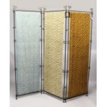 AN UNUSUAL WROUGHT IRON THREE SECTION FOLDING DRESSING SCREEN, each section having different hanging