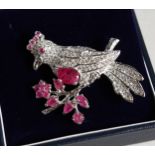 A SILVER RUBY SET BIRD BROOCH