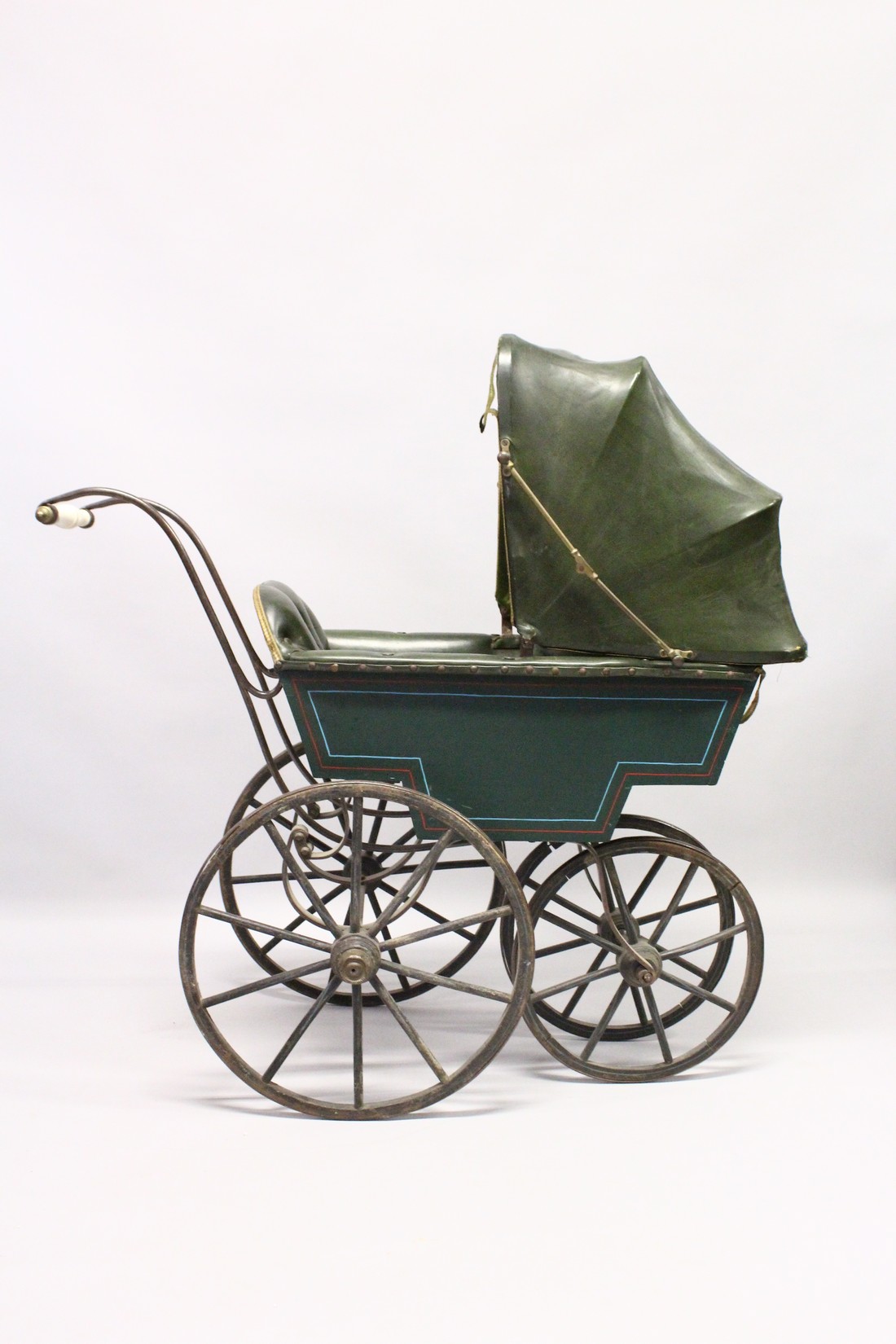 A RARE VICTORIAN METAL, WOOD AND LEATHER PRAM with folding hood, porcelain handles, wooden wheels. - Image 2 of 7