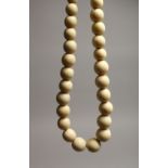 A GOOD GRADUATED IVORY BEAD NECKLACE on thirty five beads 16ins long