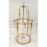 A GEORGIAN STYLE BRASS CIRCULAR HALL LANTERN 32ins high.