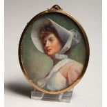 AN OVAL PORTRAIT MINIATURE OF A LADY wearing a bonnet 3ins x 2.5ins