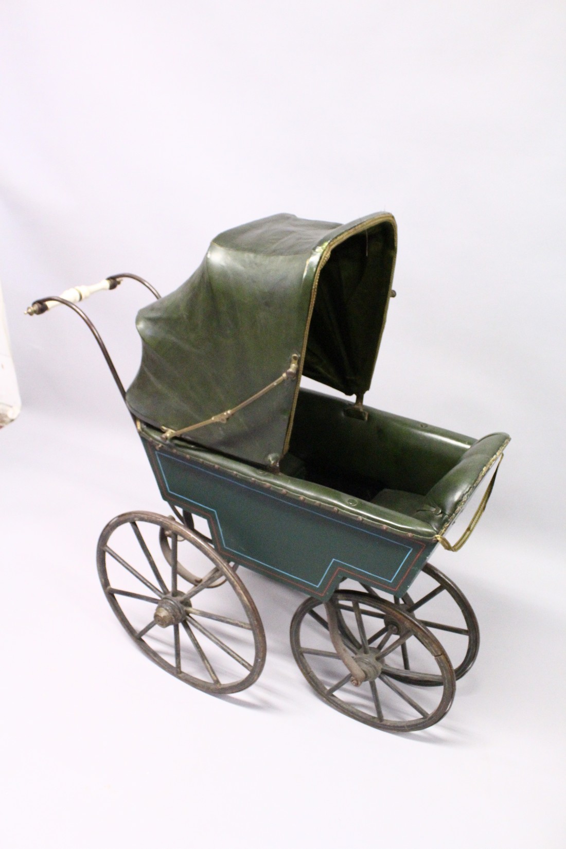 A RARE VICTORIAN METAL, WOOD AND LEATHER PRAM with folding hood, porcelain handles, wooden wheels. - Image 3 of 7