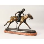 A CONTEMPORARY BRONZE MODEL OF A POLO PLAYER IN ACTION, mounted on a rouge marble base, Signed 15ins