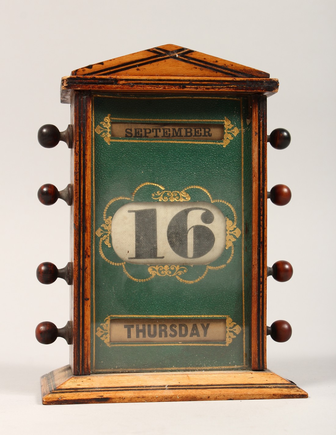 A VICTORIAN WOODEN DESK CALENDER 7ins high