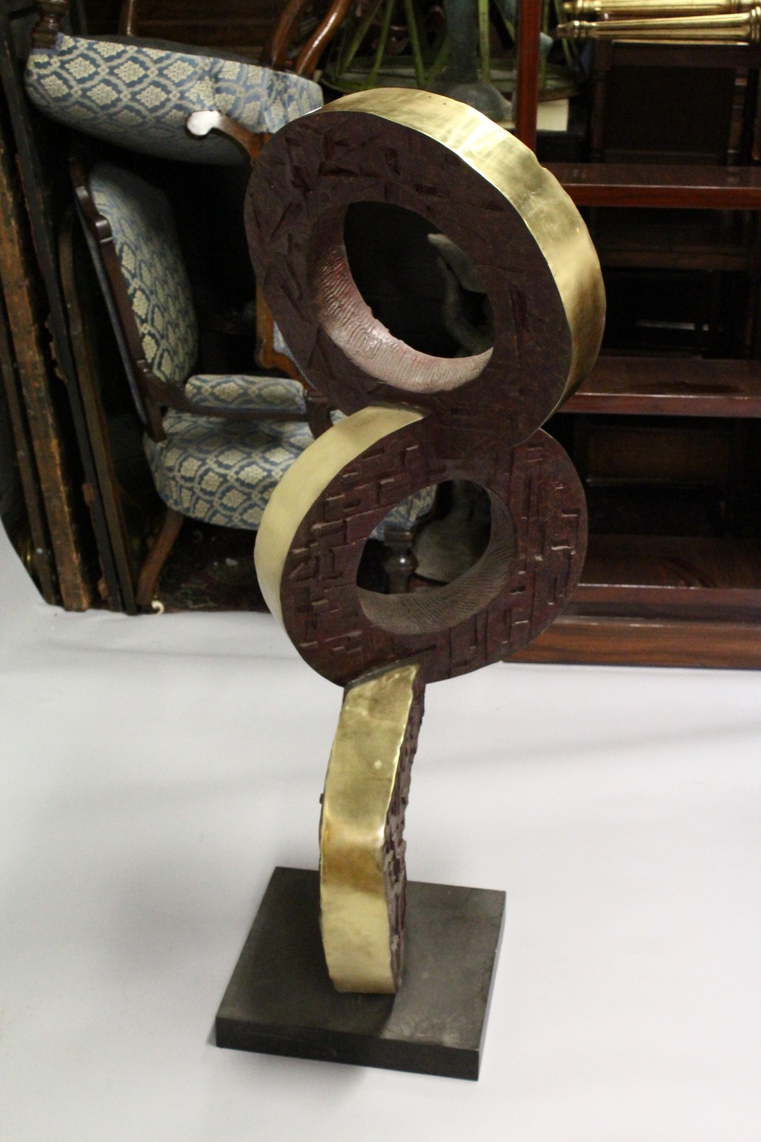 A LARGE POLISHED AND PATTINATED BRONZE ABSTRACT GROUP OF THREE CONJOINED CIRCLES, on a square base. - Image 2 of 2