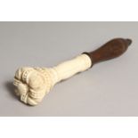 A 19TH CENTURY CARVED IVORY AND TURNED WOOD TIPSTAFF, the top as a crown 7.5ins long.