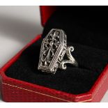 A SILVER COFFIN SHAPED RING