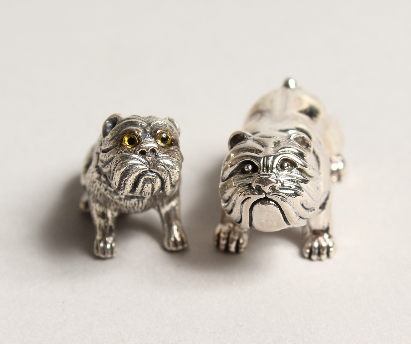 A PAIR OF NOVELTY SILVER MINI BULL DOGS