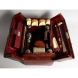 A GENTLEMAN'S CROCODILE TRAVELLING CASE with silver and ivory fittings, seven silver top bottles,