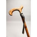 A RUSTIC WALKING CANE with leather straps 2ft 8ins long