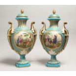 A SUPERB LARGE PAIR OF SEVRES TWO HANDLED URN SHAPED VASES AND COVERS, blue ground edged in gilt and