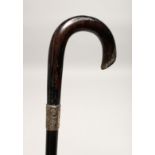 A VICTORIAN WALKING STICK with silver band Birmingham 1874