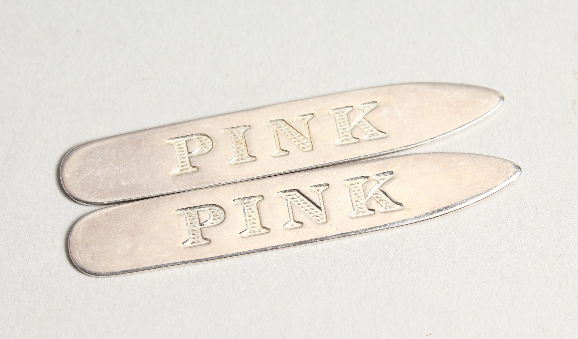 A PAIR OF 'PINK' BOXED SILVER COLLAR STIFFENERS.