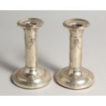 A PAIR OF SILVER CANDLESTICKS, each with ribbon and swag embossed decoration, Birmingham 1904, 4.