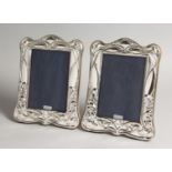 A PAIR OF SILVER PHOTOGRAPHS FRAMES, in Art Nouveau style 8ins x 6.25ins