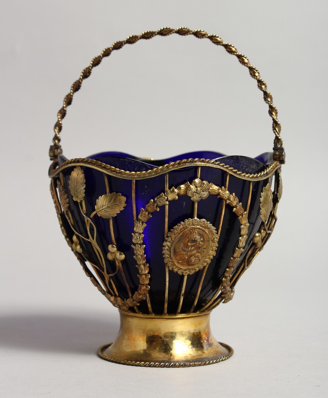 A GOOD GEORGE III SILVER GILT SUGAR BASKET with garlands and medallions and twist handle. London