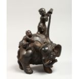 A CHINESE BRONZE GROUP OF TWO CHILDREN WASHING AN ELEPHANT 9ins high.