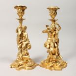 A PAIR OF CLASSICAL STYLE GILT BRONZE FIGURAL CANDLESTICKS 11.5ins high.