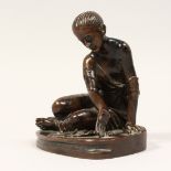 A BARBIDIENNE BRONZE DICE PLAYER in a circular base.