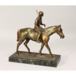 A SPELTER MODEL OF A POLO PLAYER ON HORSEBACK on a rectangular marble base. 10.5ins high