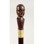 A WALKING STICK, the handle modelled as a phrenology head. 36ins long.