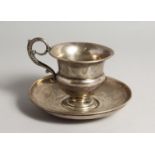 A FRENCH SILVER CUP AND SAUCER, with engraved decoration Saucer 6ins diameter.