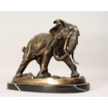 A CONTEMPORARY CAST BRONZE MODEL OF A BULL ELEPHANT on an oval marble base. 11.25ins long.