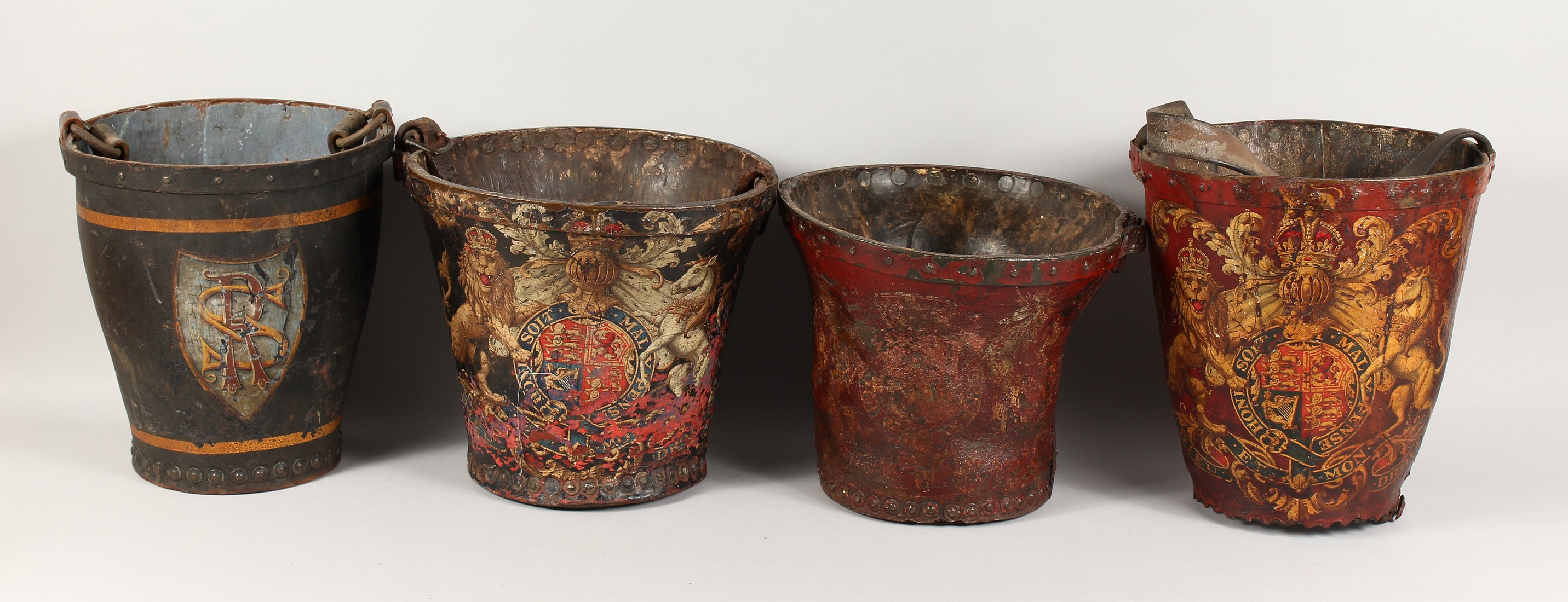 FOUR EARLY 18TH CENTURY LEATHER FIRE BUCKETS with various coat of arms.