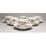 A SET OF SIX 18TH CENTURY MEISSEN PORCELAIN SHAPED CUPS AND SAUCERS,painted with flowers and