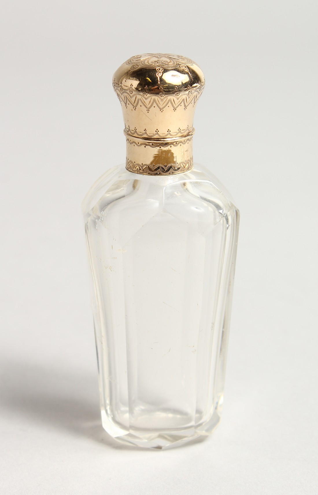 A TAPERING GLASS TOP SCENT BOTTLE 3.5ins long.