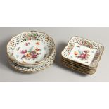 A CONTINENTAL PORCELAIN PIERCED DESSERT SET painted with flowers comprising circular dishes, 9ins