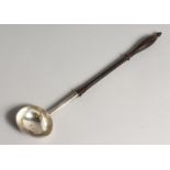 A GEORGE II PUNCH LADLE with plain bow and turned wood handle 14ins long London 1728 maker J.C..
